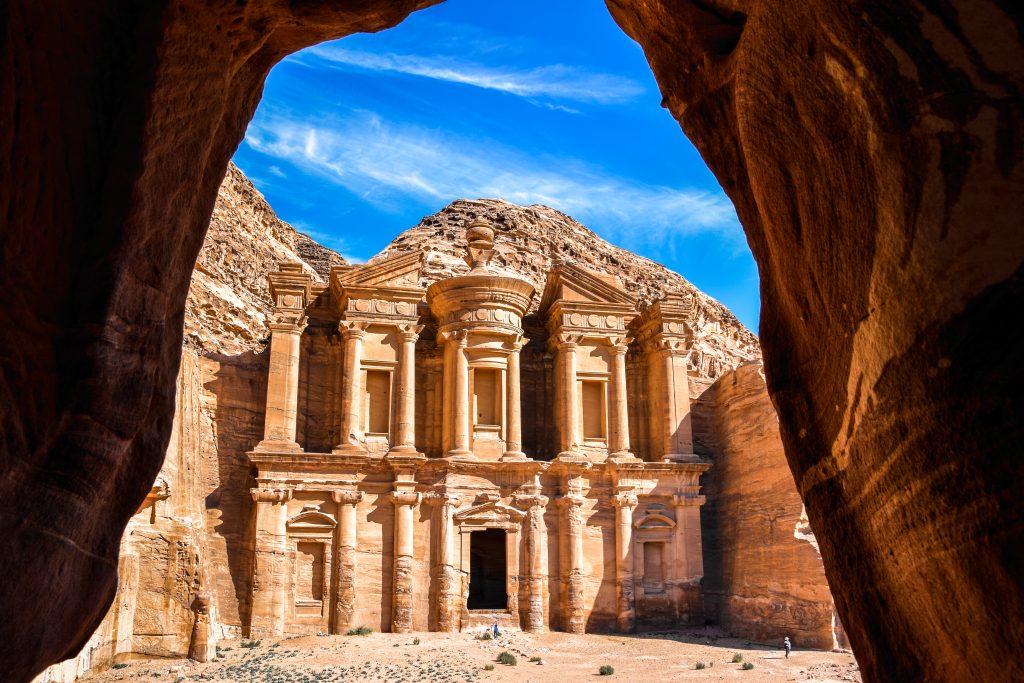 Petra Treasury at sunrise — the iconic rose-red façade carved into sandstone cliffs in Jordan
